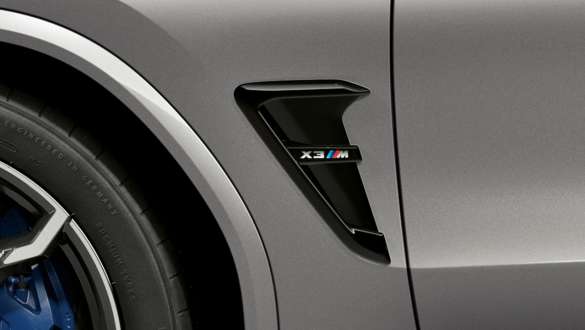 BMW X3 M Competition, ouïes M avec insigne du modèle. Extérieur de la BMW X3 M Competition en Donington Grau metallic, ouïes M en Schwarz hochglänzend avec insigne du modèle.