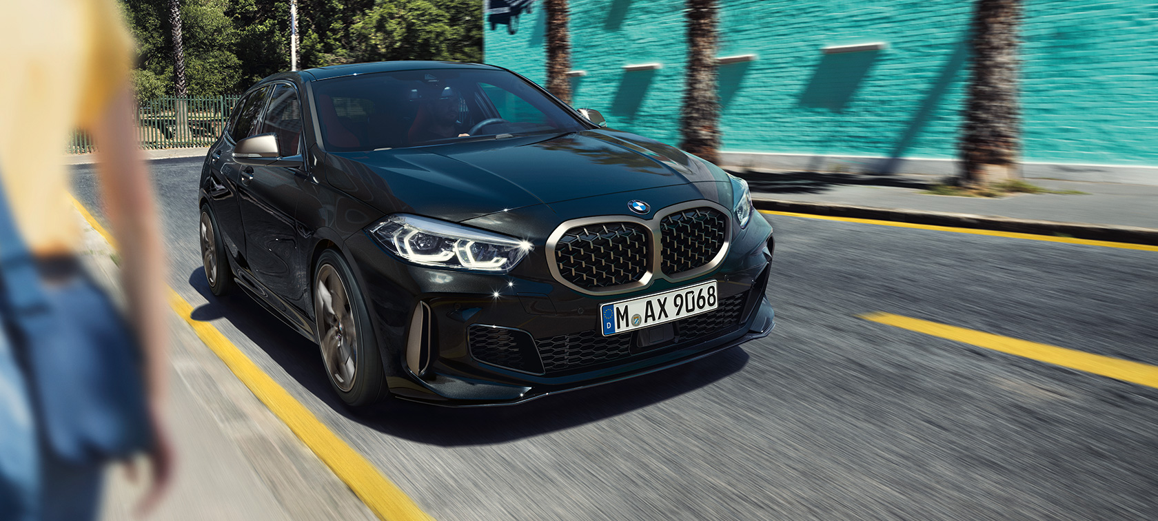 BMW M135i xDrive (F40), three-quarter front view BMW M135i xDrive (F40) in Black Sapphire metallic, three-quarter front view driving