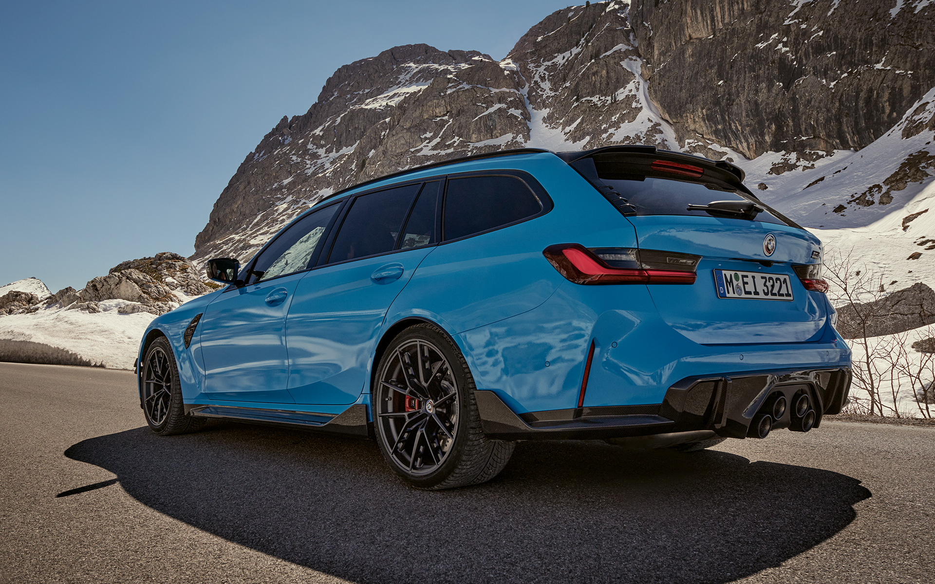 BMW M3 Touring G81 BMW M Performance Parts vue de trois quarts de profil en mouvement BMW M3 Touring G81 BMW M Performance Parts vue de trois quarts de profil en mouvement devant un paysage de montagnes